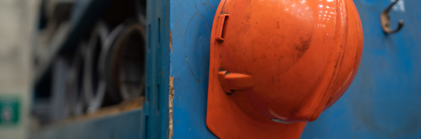 A hard hat hanging up on a hook.